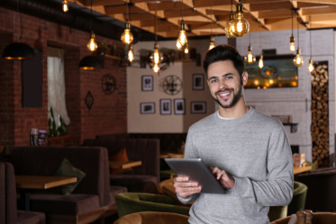 male pub owner ready to receive patrons in his pub